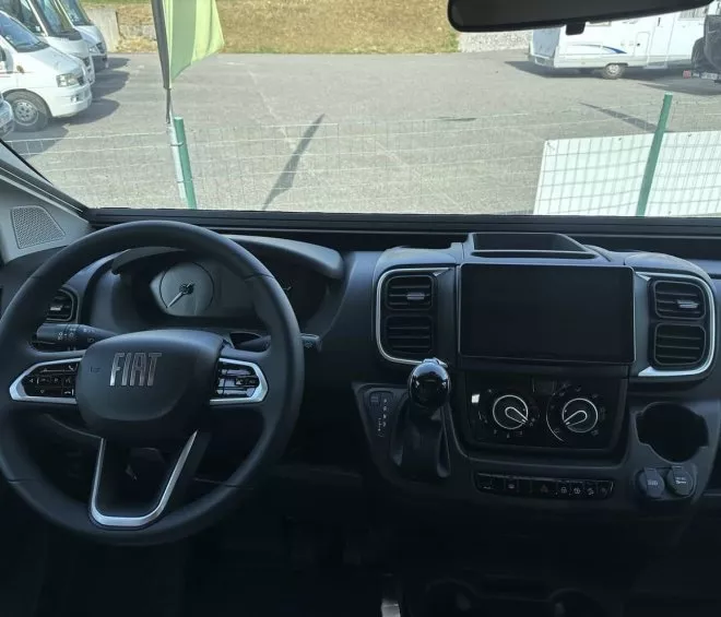 Intérieur d'un véhicule Fiat avec volant et tableau de bord visibles