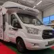Camping-car Chausson exposé dans un showroom avec tapis rouge