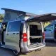 Vans aménagés avec toits relevables en stationnement extérieur