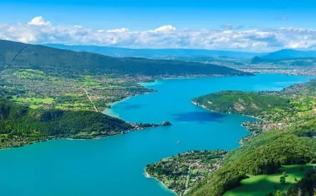 Vue aérienne du lac entouré de montagnes et de forêts verdoyantes