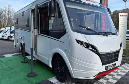 Camping-car Dethleffs blanc exposé sur un parking avec d'autres véhicules similaires.