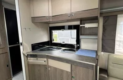 Cuisine compacte de caravane avec évier et rangements en bois clair