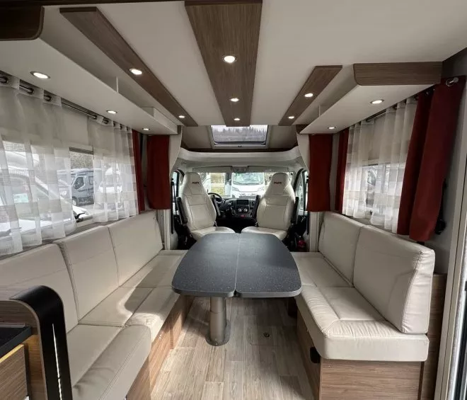 Intérieur d'un camping-car moderne avec sièges en cuir et table centrale