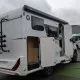 Camping-car Sunlight avec porte ouverte sur un parking de concessionnaire
