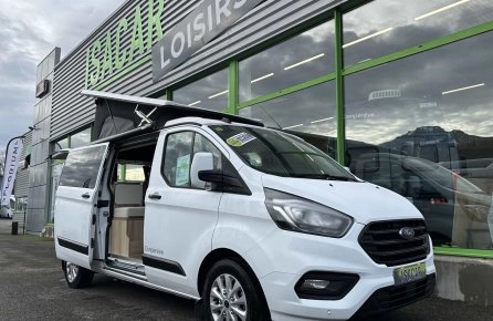 Camping-car blanc devant le magasin Isacar Loisirs