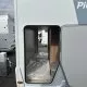 Compartiment de rangement ouvert d'un camping-car sur un parking