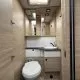 Salle de bain compacte en bois clair avec toilettes et lavabo moderne
