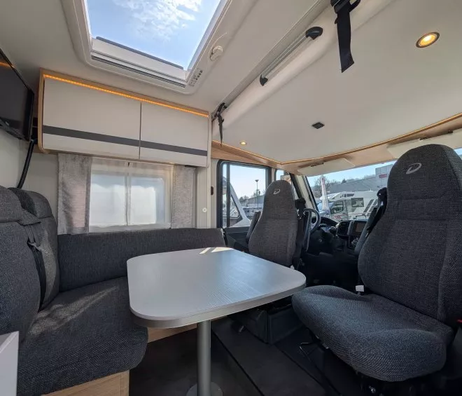 Intérieur d'un camping-car moderne avec table et sièges rembourrés