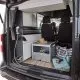 Intérieur d'un van aménagé avec douche et espace de rangement