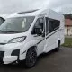 Camping-car Sunlight V60 blanc stationné sur un parking