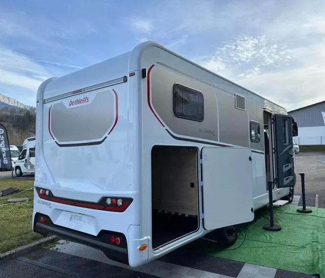 Camping-car Dethleffs Globebus GT exposé en extérieur avec montagnes en arrière-plan.