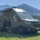 Véhicule utilitaire Ford aménagé en camping-car sur fond de montagnes